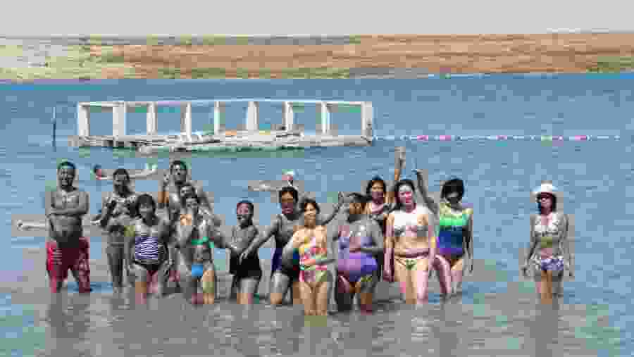 Tourists enjoying mud bath at Dead Sea