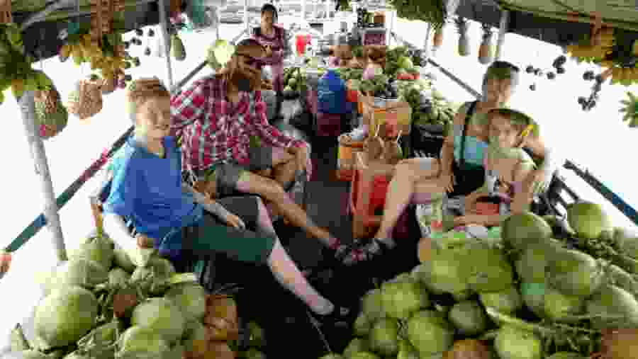 Tourist family on the fruit boat