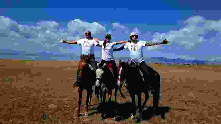 Travelers horse riding in Kyrgyzstan