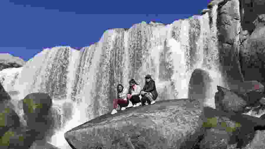 Travellers at the Pillones waterfall