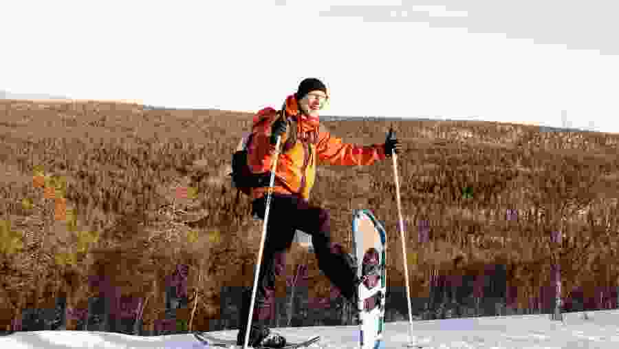 Happy tourist with his snowshoes