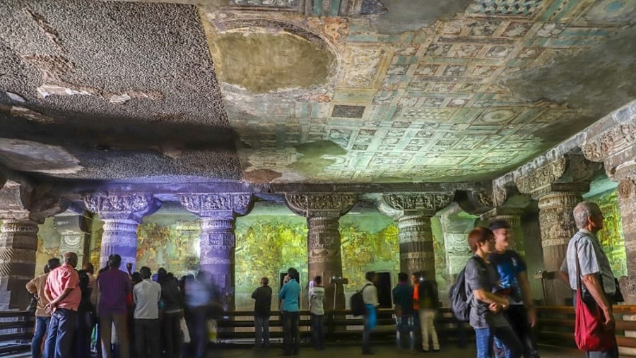 tourists enjoy paintings and rock-cut sculptures the finest surviving ancient Indian art in Ajanta Buddhist cave dated from the 200 BCE to 480 CE in Aurangabad.