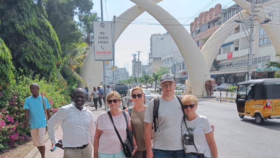 A Group of Travellers Posing with the Elephant Tusks at Moi Avenue