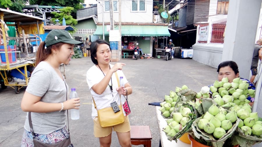 Visit a street market in Thonburi