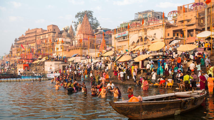 Pilgrims plunge into the water holy Ganges river in the early morning. According to legends, the city was founded by God Shiva about 5000 years ago.