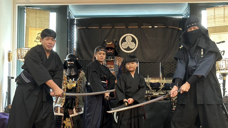 Travelers posing in the dojo