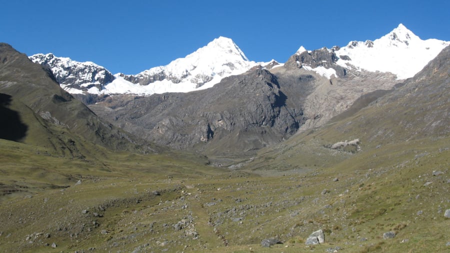 Green pastures and snow capped mountains