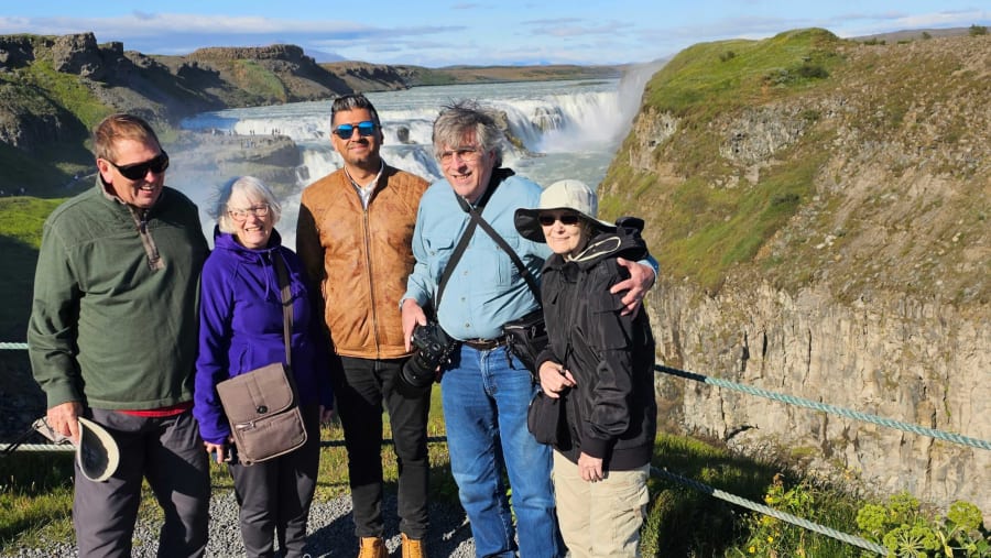 Travelers near the waterfall