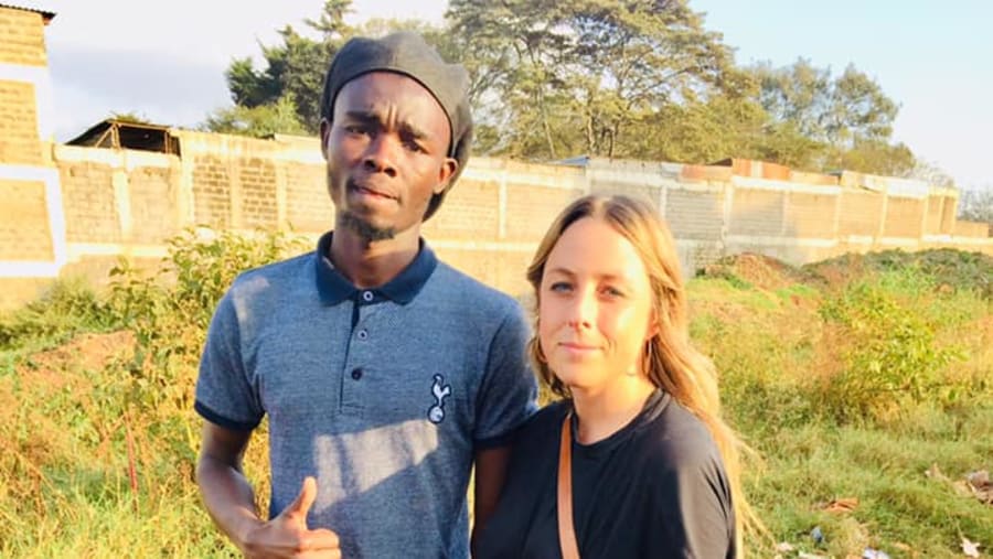 A Tourist with the Tour Guide in Kibera Slum