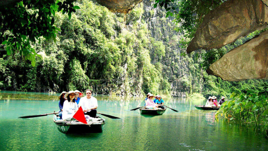 Boating through the river in Trang An Grottoes