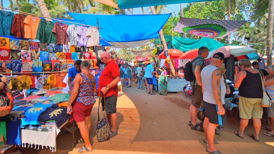 Tourists shopping at the Anjuna flea market in Goa.