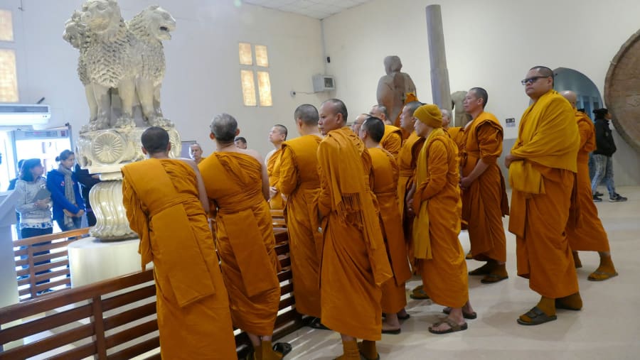 Buddhist monks examine sculptures in the museum at Sarnath near Varanasi.