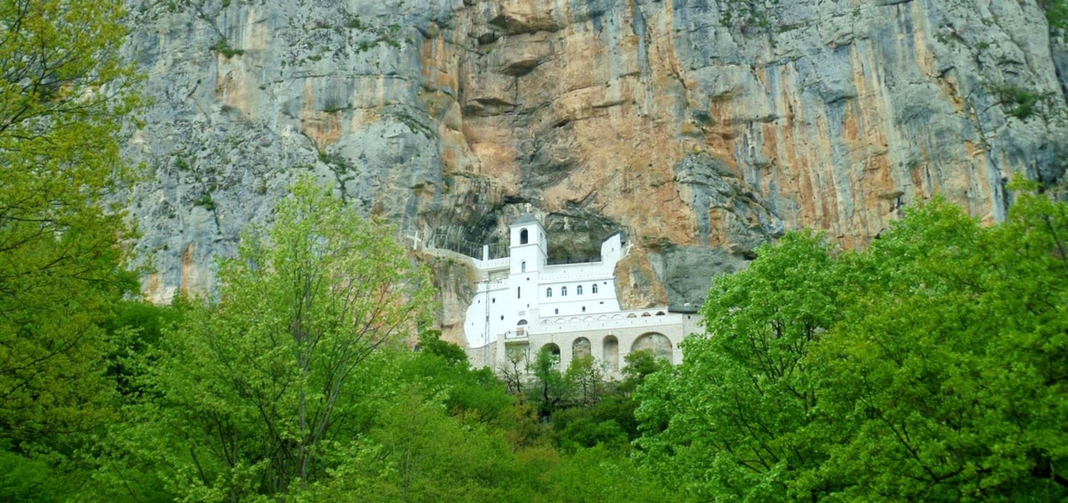 Ostrog Monastery set into the rock, highland road, views over the valley, Niksic