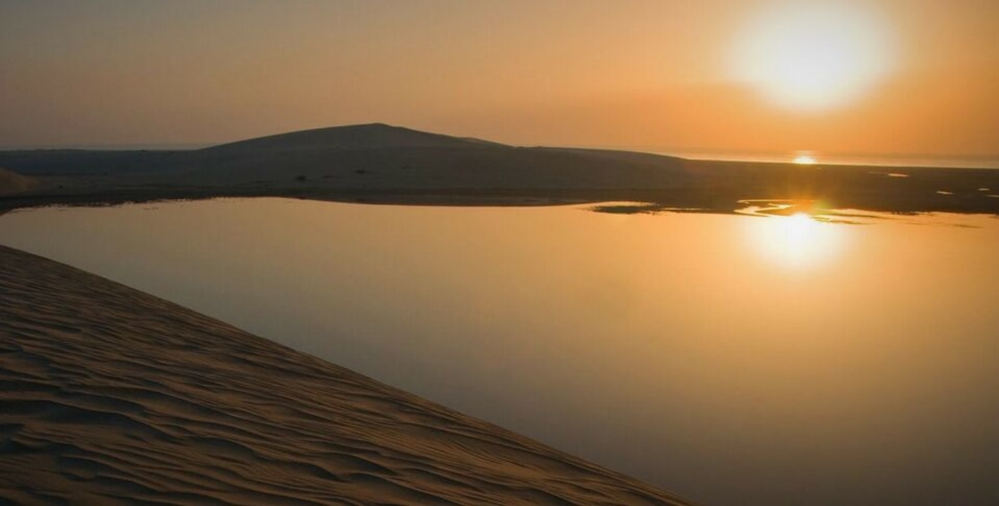Mesaieed City and oil refineries, desert dunes and sandboarding, camel camp and local tea, Khor Al Adaid Inland Sea