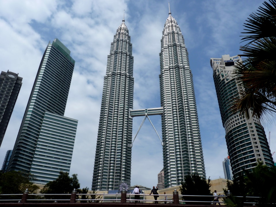 Cliffside Batu Caves, Petronas Towers skyline, Independence Square lawns