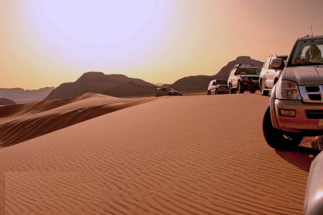 Wadi Rum Visitor Center, towering sandstone cliffs, red sand dunes