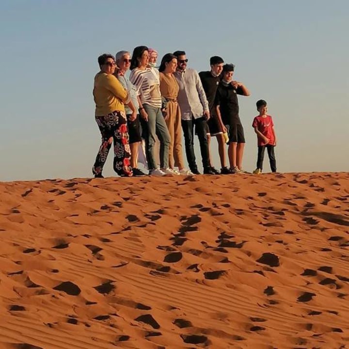 red sand dunes, dune bashing and sandboarding, short traditional camel ride