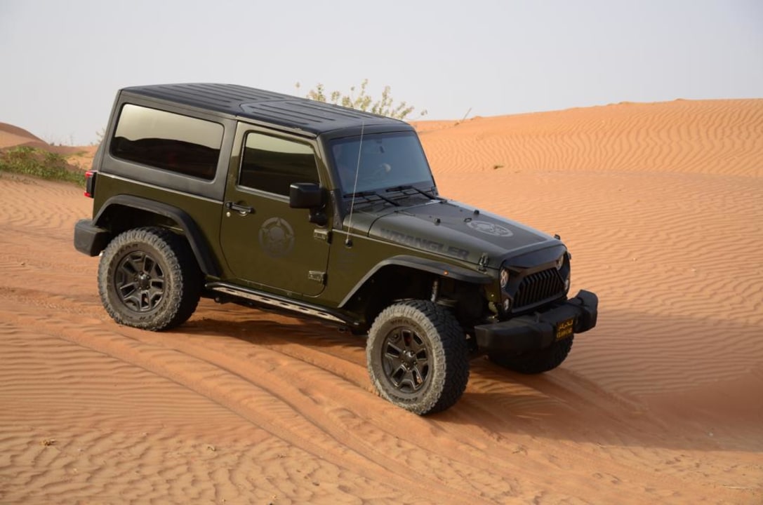 Ras al Khaimah dunes, breathtaking desert sunset, traditional Bedouin-style camp