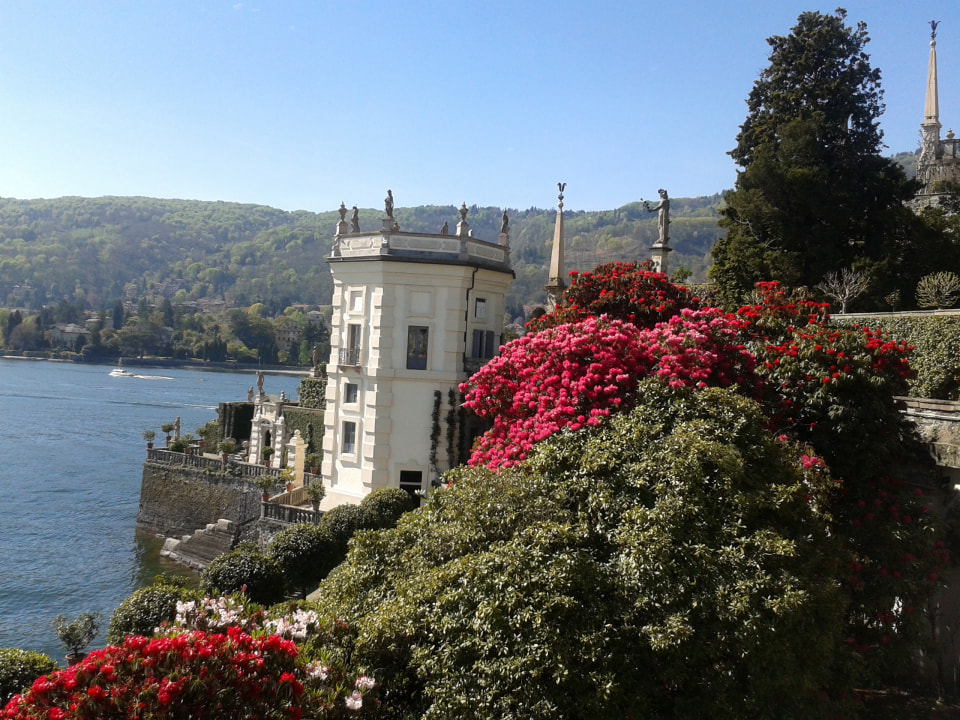 Isola Bella Baroque palace, luxuriant Italian-style gardens, Church of San Vittore spire