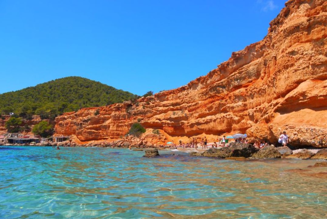 Sa Caleta, red clay cliffs, crystal clear waters, pine trees