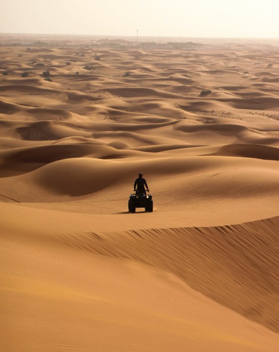 Al Madam Desert, high red dunes, dune bashing at sunset