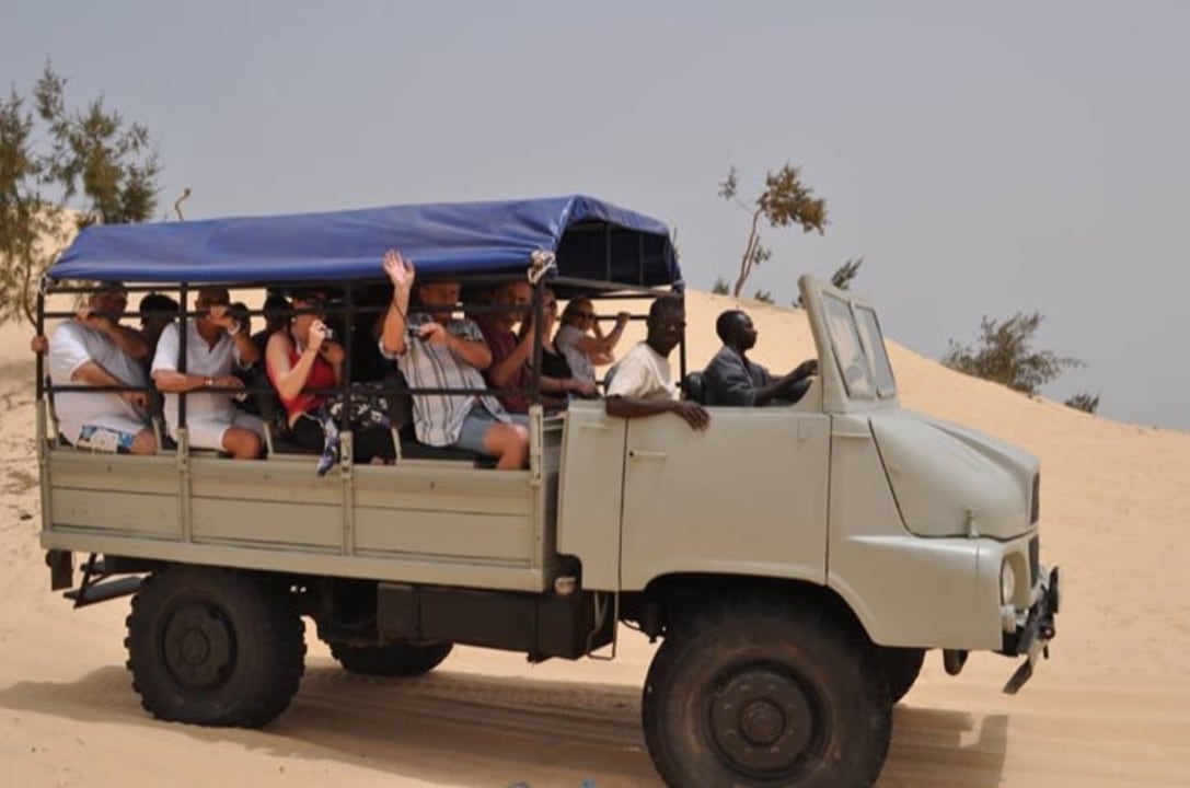 Pink Lake shores, salt harvesters at work, former Dakar Rally tracks, Senegalese suburbs