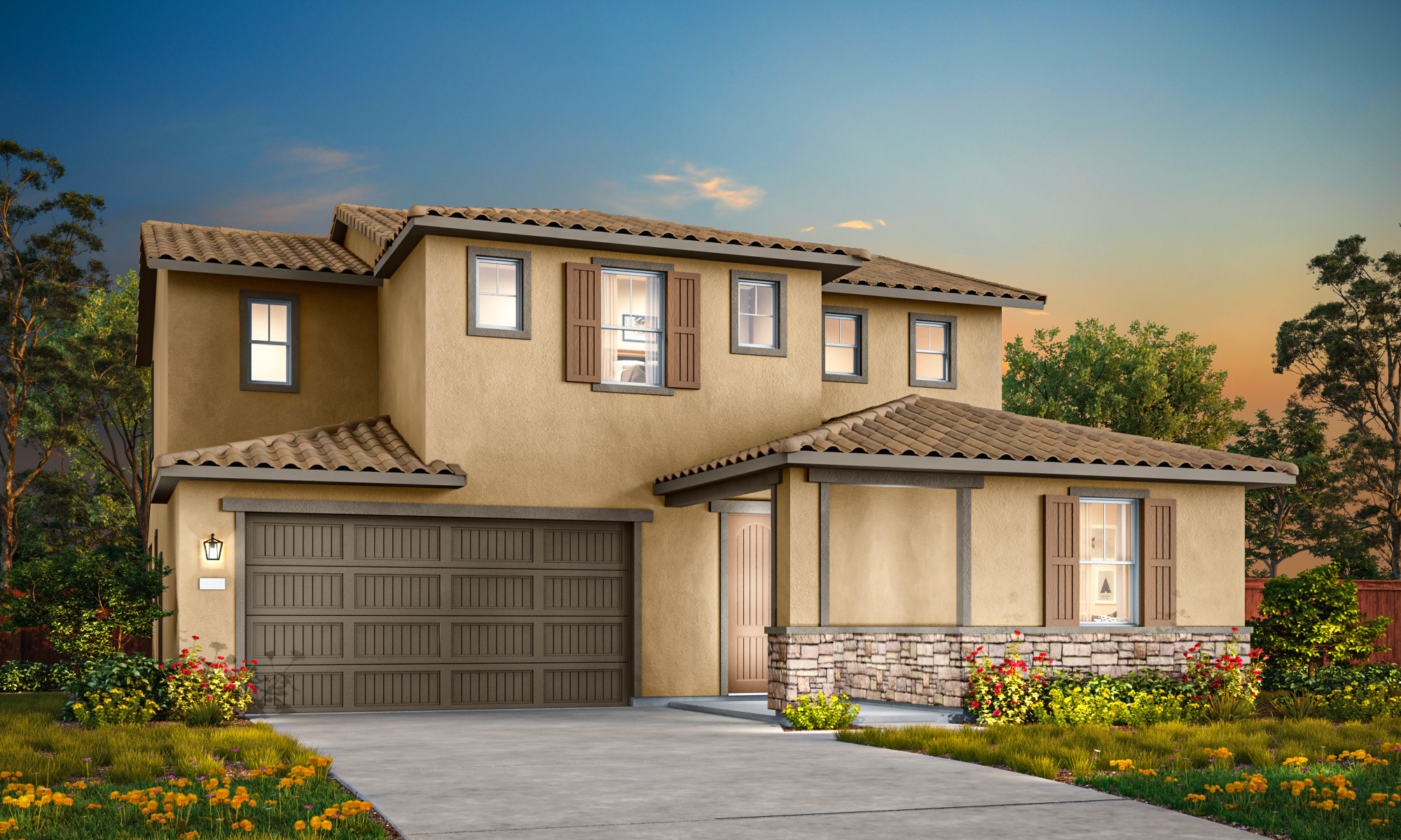 A two-story Mediterranean-style house with a tiled roof, a garage door, and a landscaped yard with colorful flowers in the foreground, set against a backdrop of a blue sky with clouds.