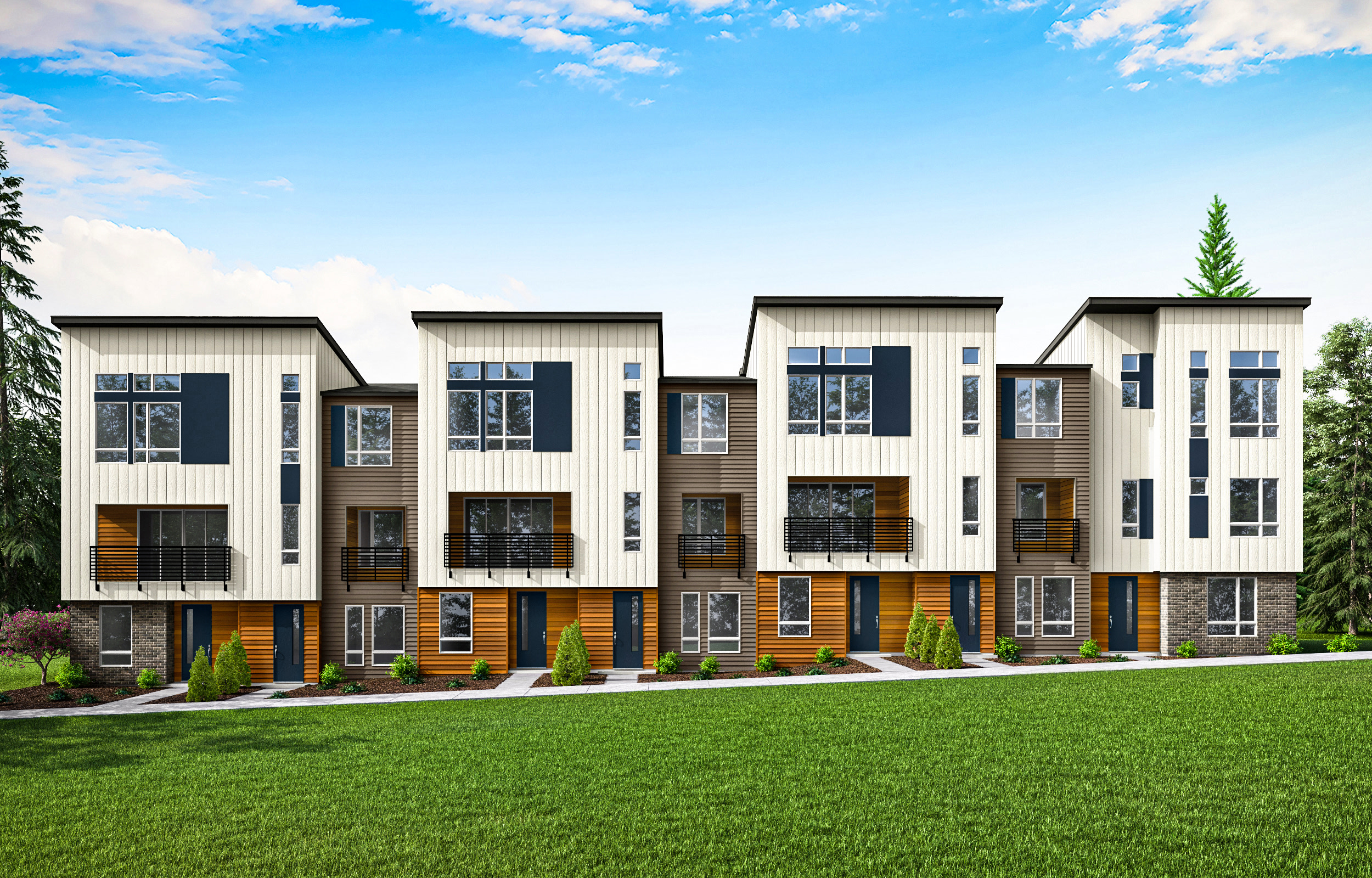 A row of modern, multi-story townhouses with a well-manicured lawn in the foreground and a blue sky with scattered clouds in the background.