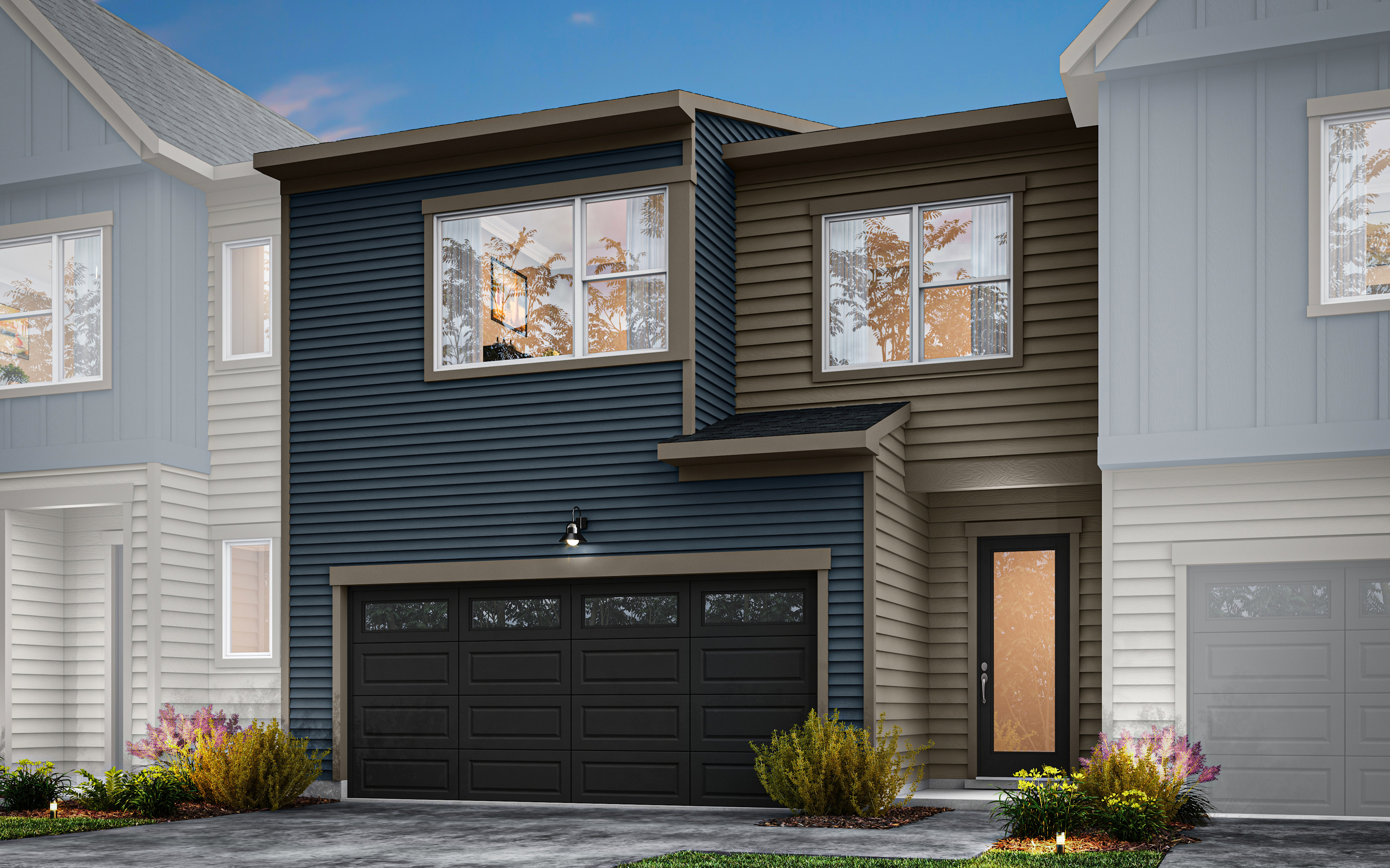 A modern, two-story townhouse with a black garage door, gray siding, and large windows overlooking a well-landscaped front yard.