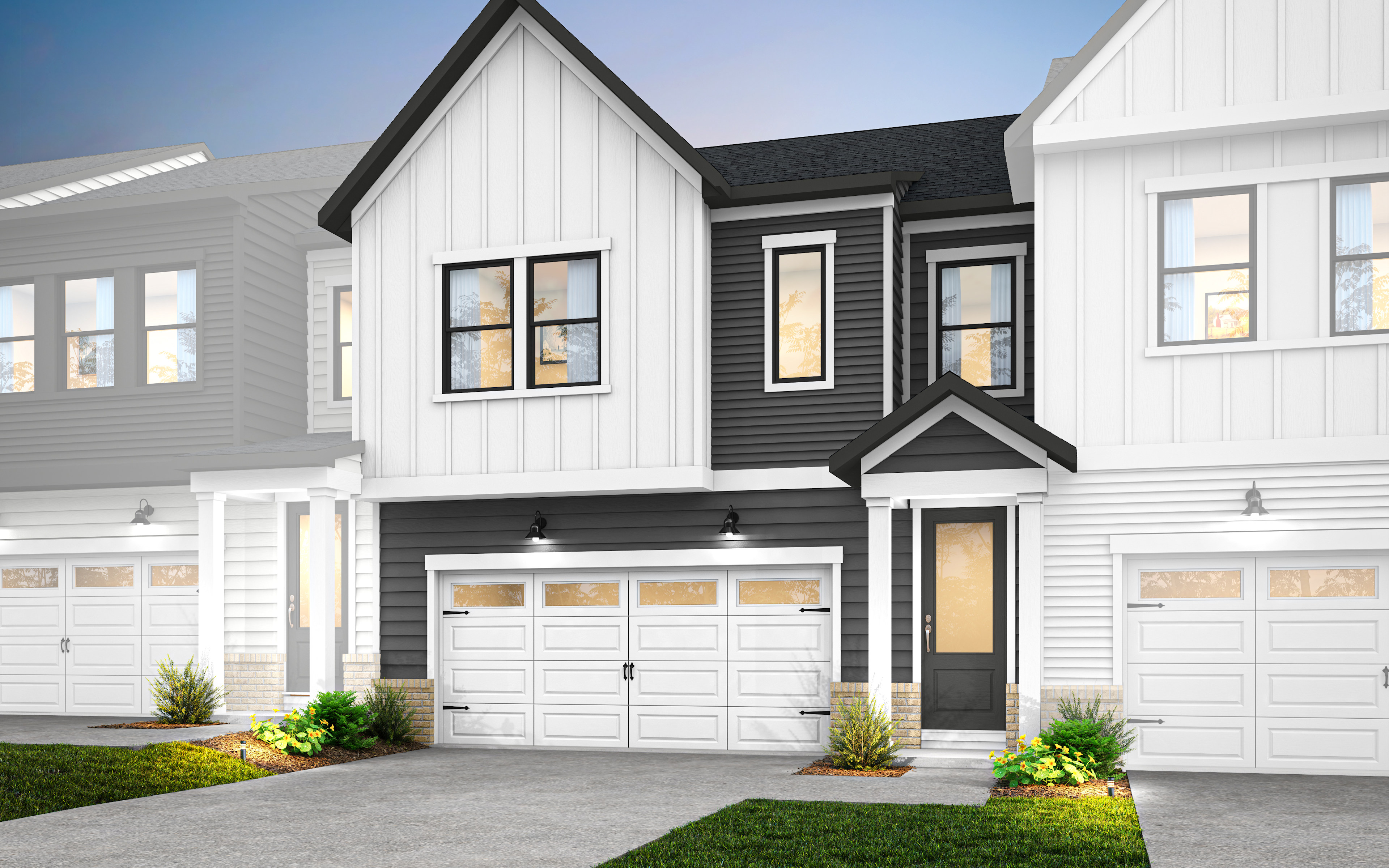 A modern two-story townhouse with a white exterior, black trim, and a garage door in the foreground, set against a clear blue sky in the background.
