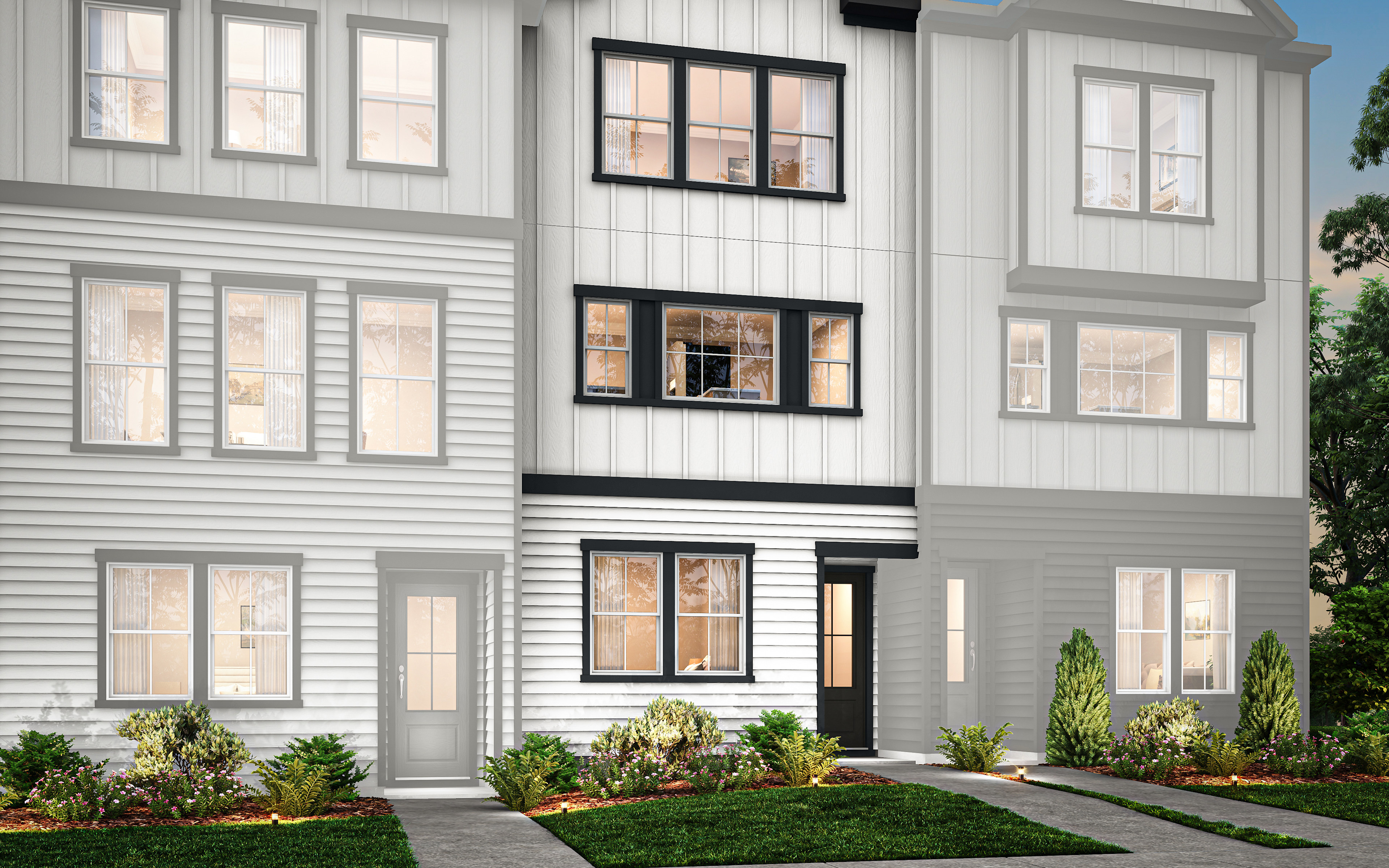 A modern, multi-story townhouse with a gray exterior, large windows, and a well-landscaped front yard surrounded by trees and shrubs.