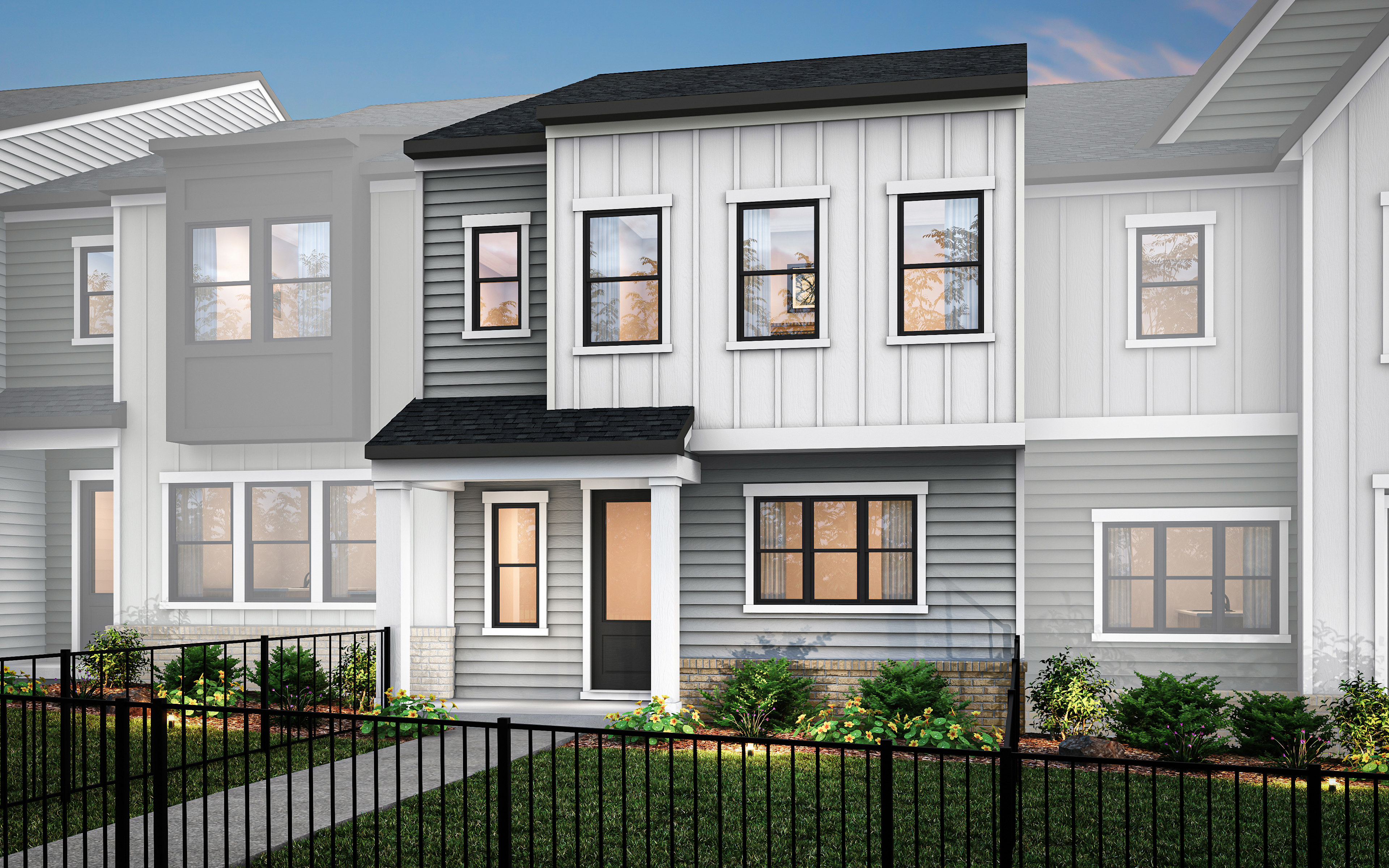 A modern, two-story townhouse with a gray exterior, white trim, and a black roof, surrounded by a metal fence and landscaping in the foreground.