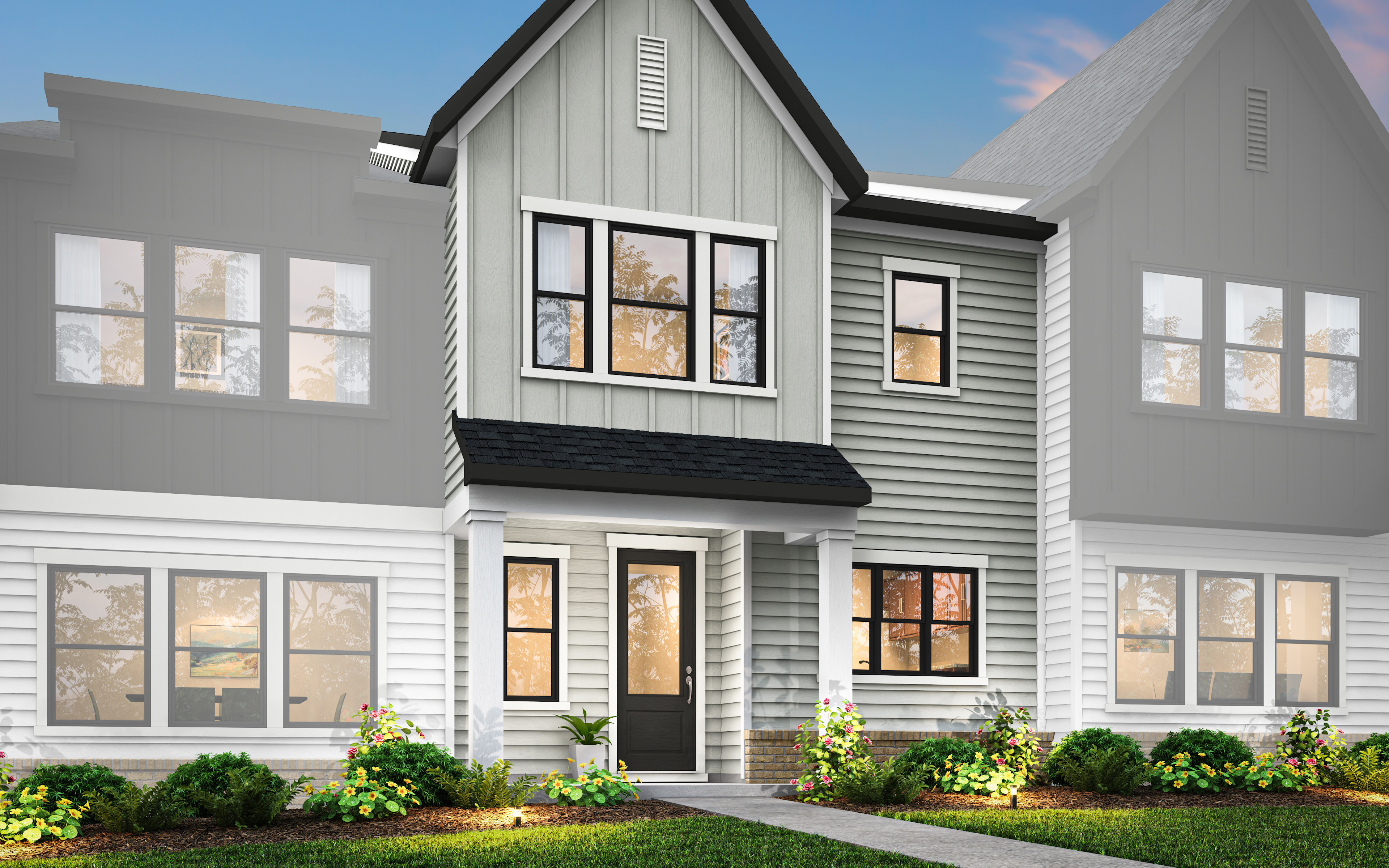A modern two-story house with a gabled roof, gray siding, and large windows surrounded by lush greenery in the foreground.
