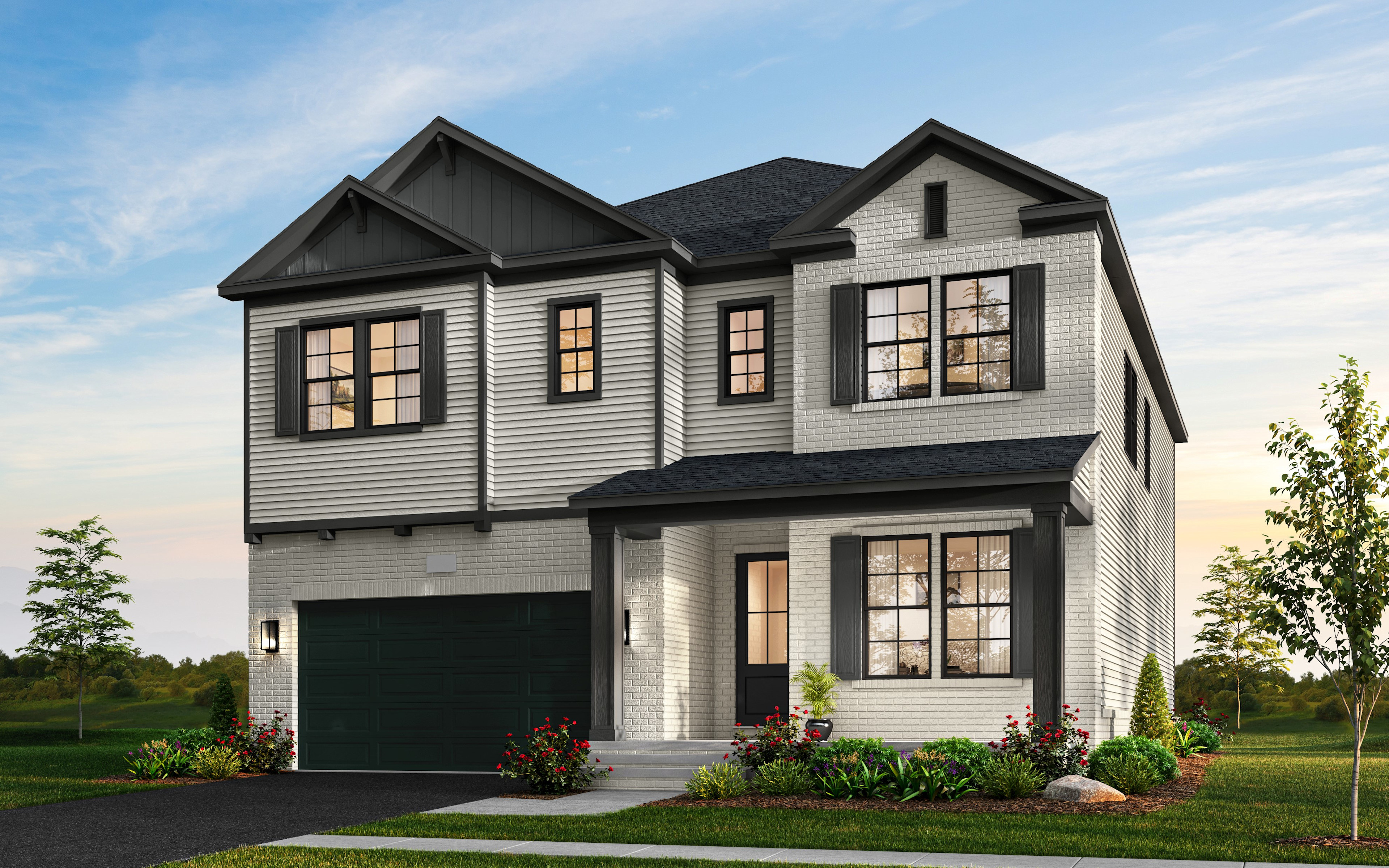 A two-story gray and white house with a garage, surrounded by a well-landscaped yard with trees and flowers in the foreground, set against a backdrop of a clear blue sky.
