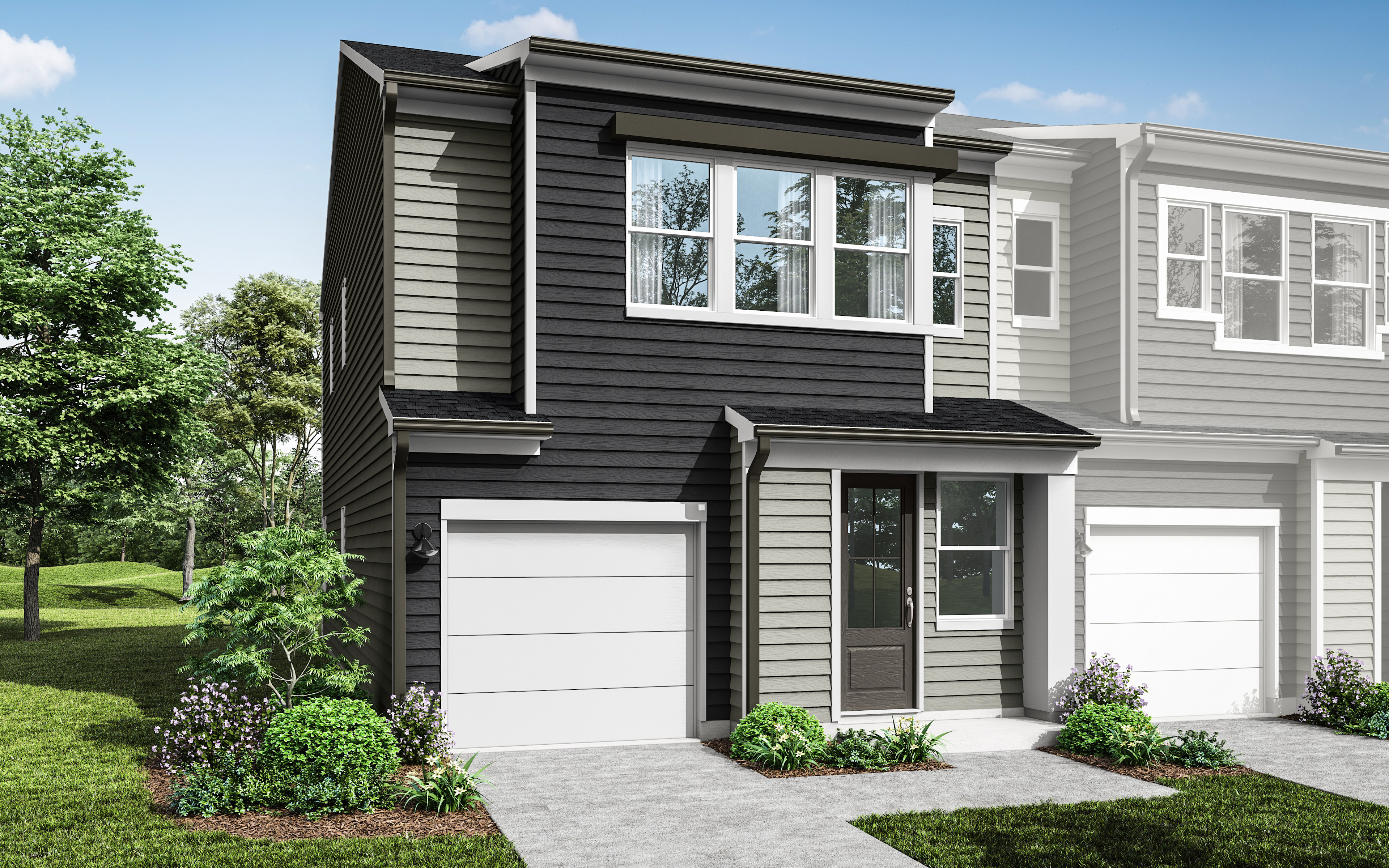 A modern two-story townhouse with a garage, surrounded by lush greenery and a well-manicured lawn in the foreground.