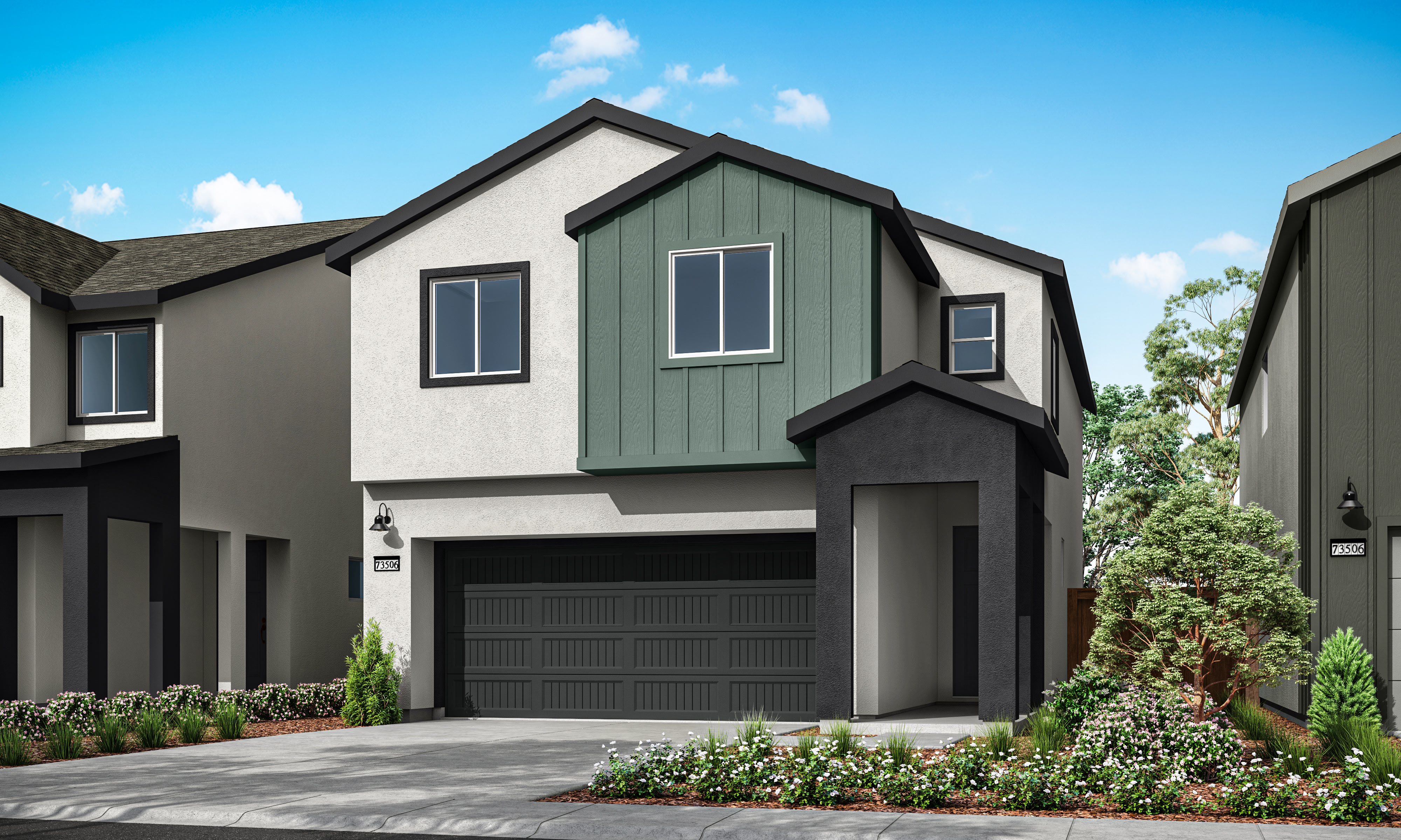A modern two-story townhouse with a dark green exterior, a black garage door, and a well-landscaped front yard featuring various plants and flowers against a backdrop of a clear blue sky with fluffy white clouds.