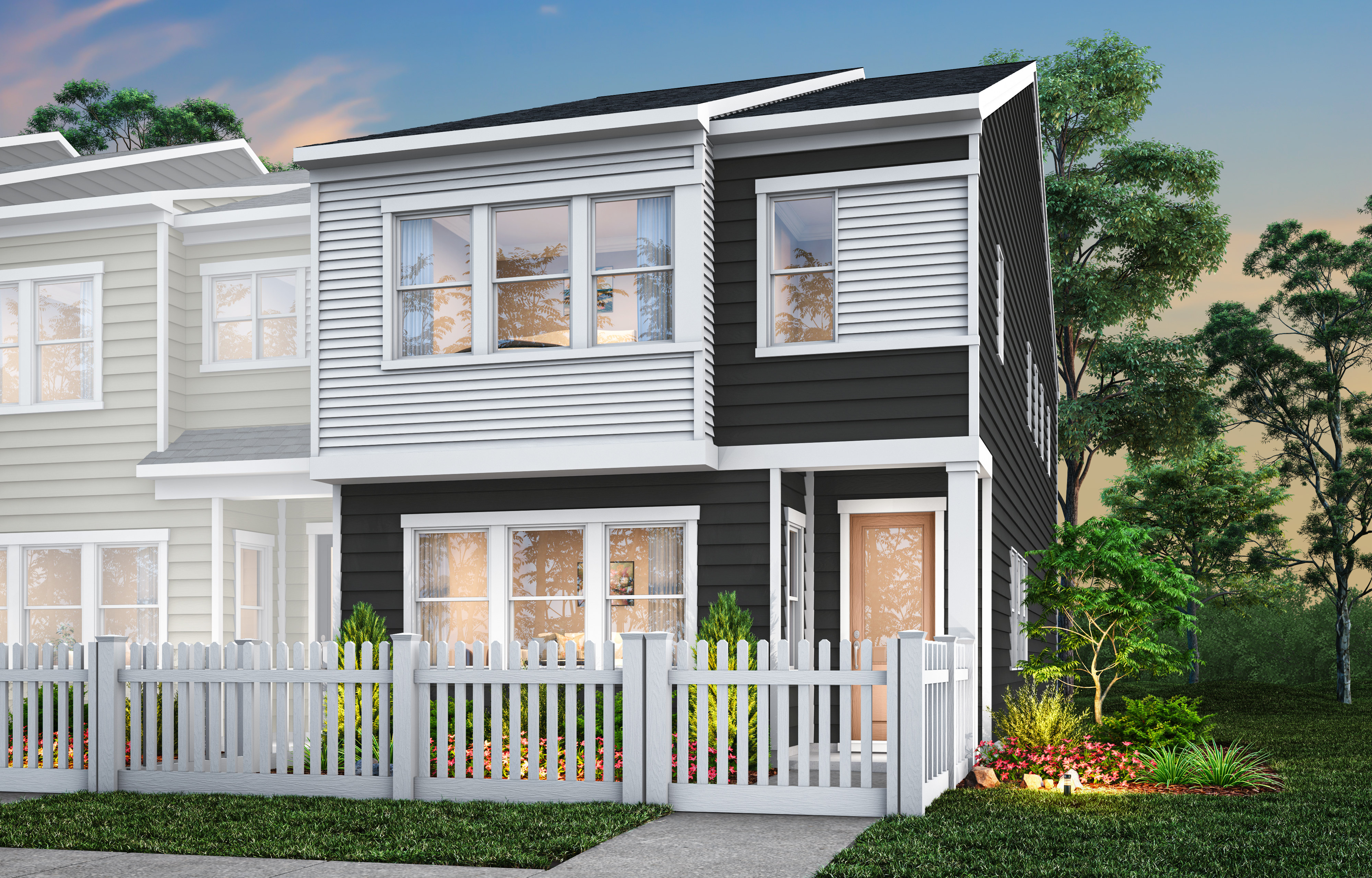 A modern two-story townhouse with a white exterior, black trim, and a fenced-in yard surrounded by lush greenery and a vibrant sky.