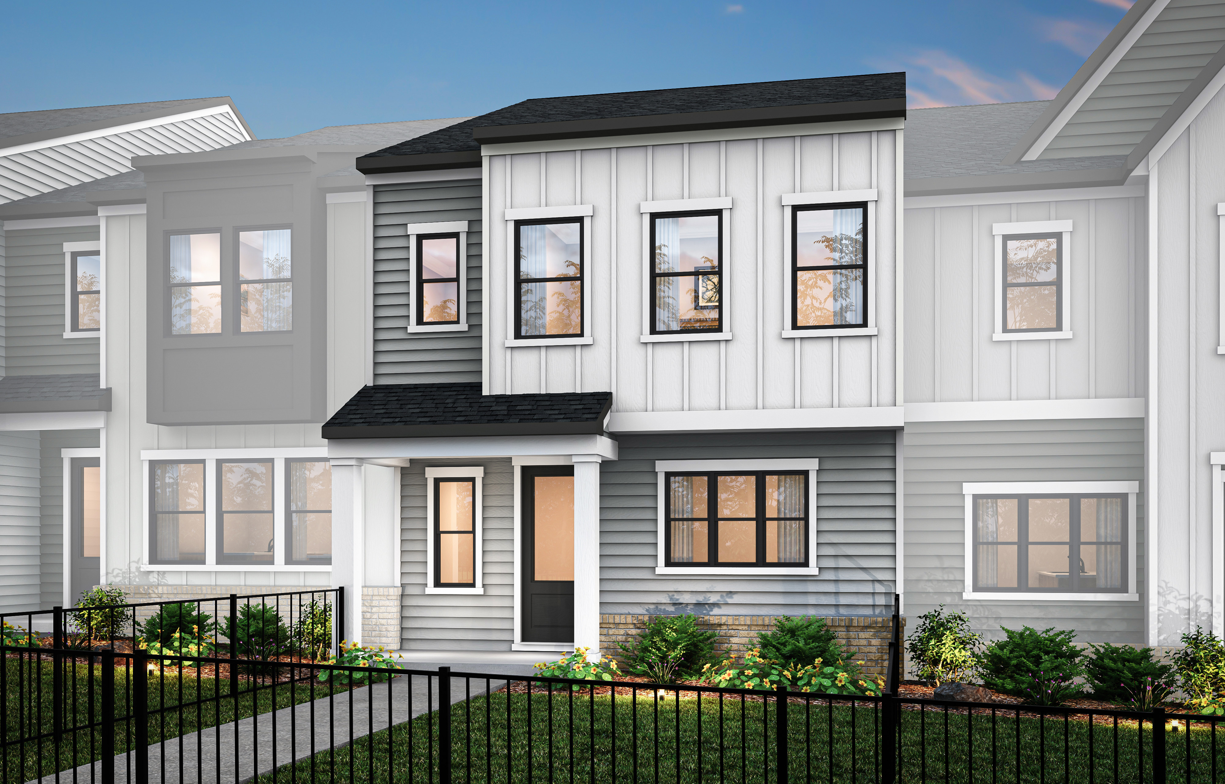 A modern, two-story townhouse with a gray exterior, white trim, and a black roof, surrounded by a metal fence and landscaping in the foreground.