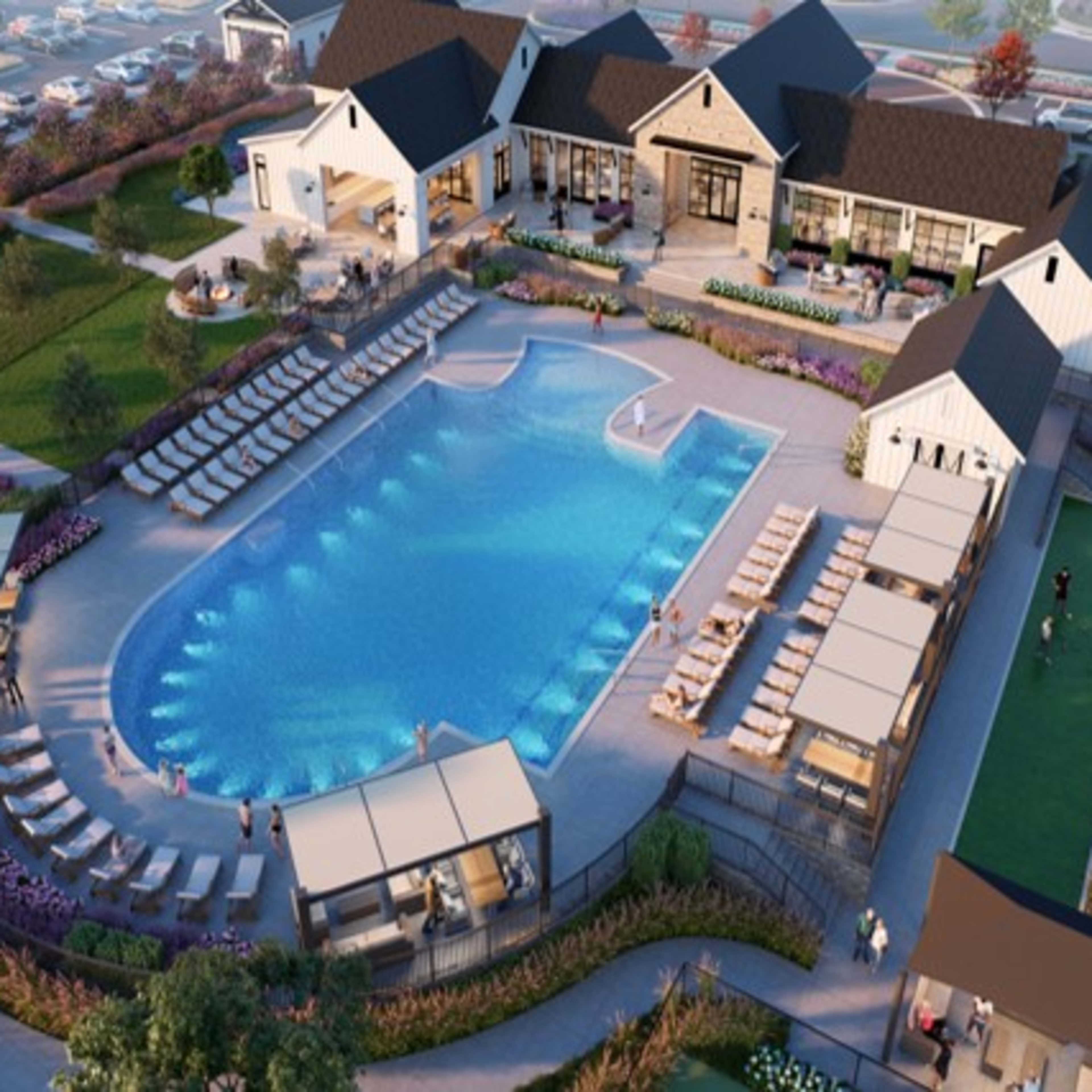 A luxurious resort with a large outdoor pool surrounded by buildings, lounge chairs, and lush greenery, set against a backdrop of a scenic landscape.