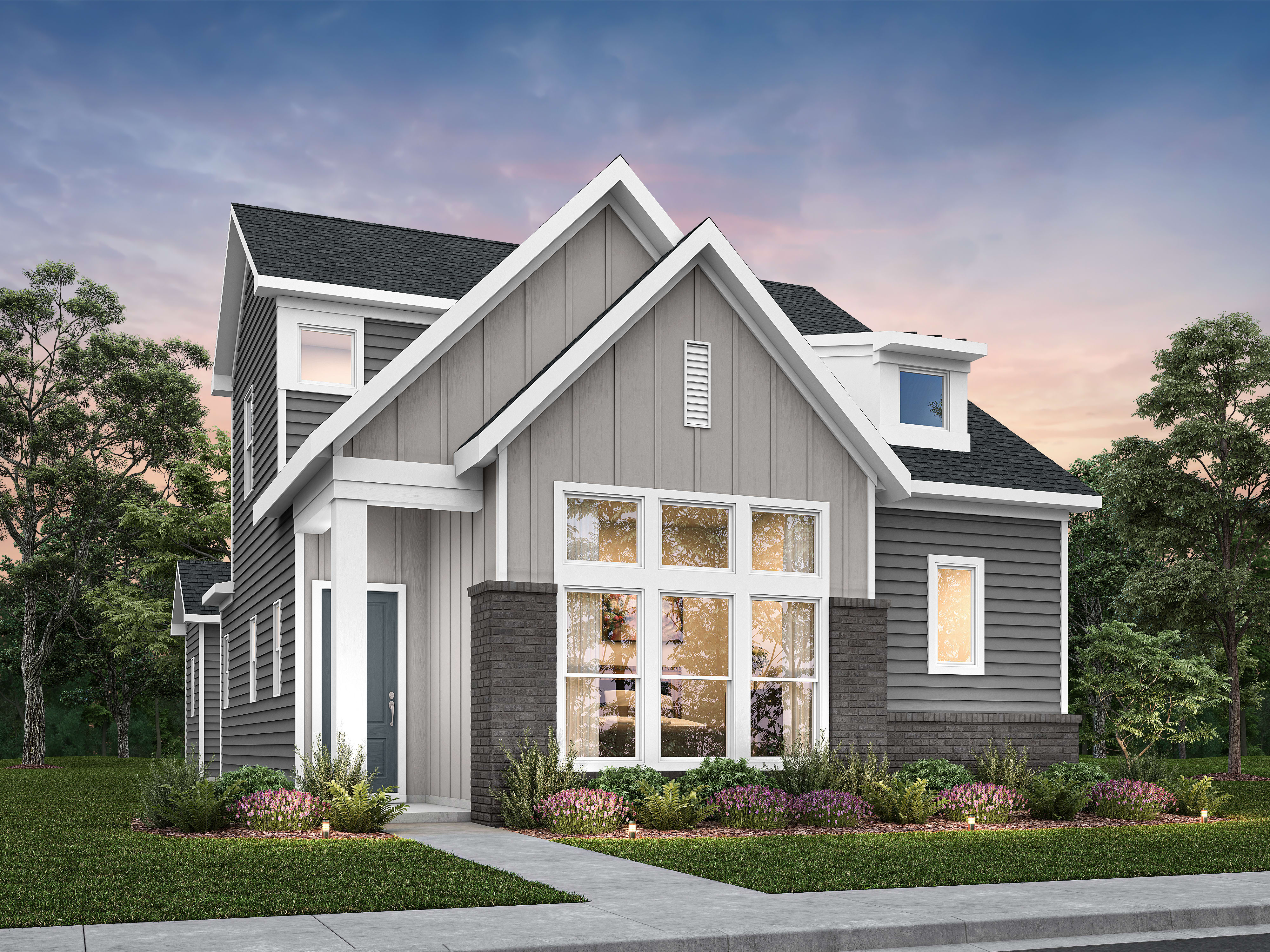 A modern gray house with a large front window and manicured landscaping sits under a twilight sky.