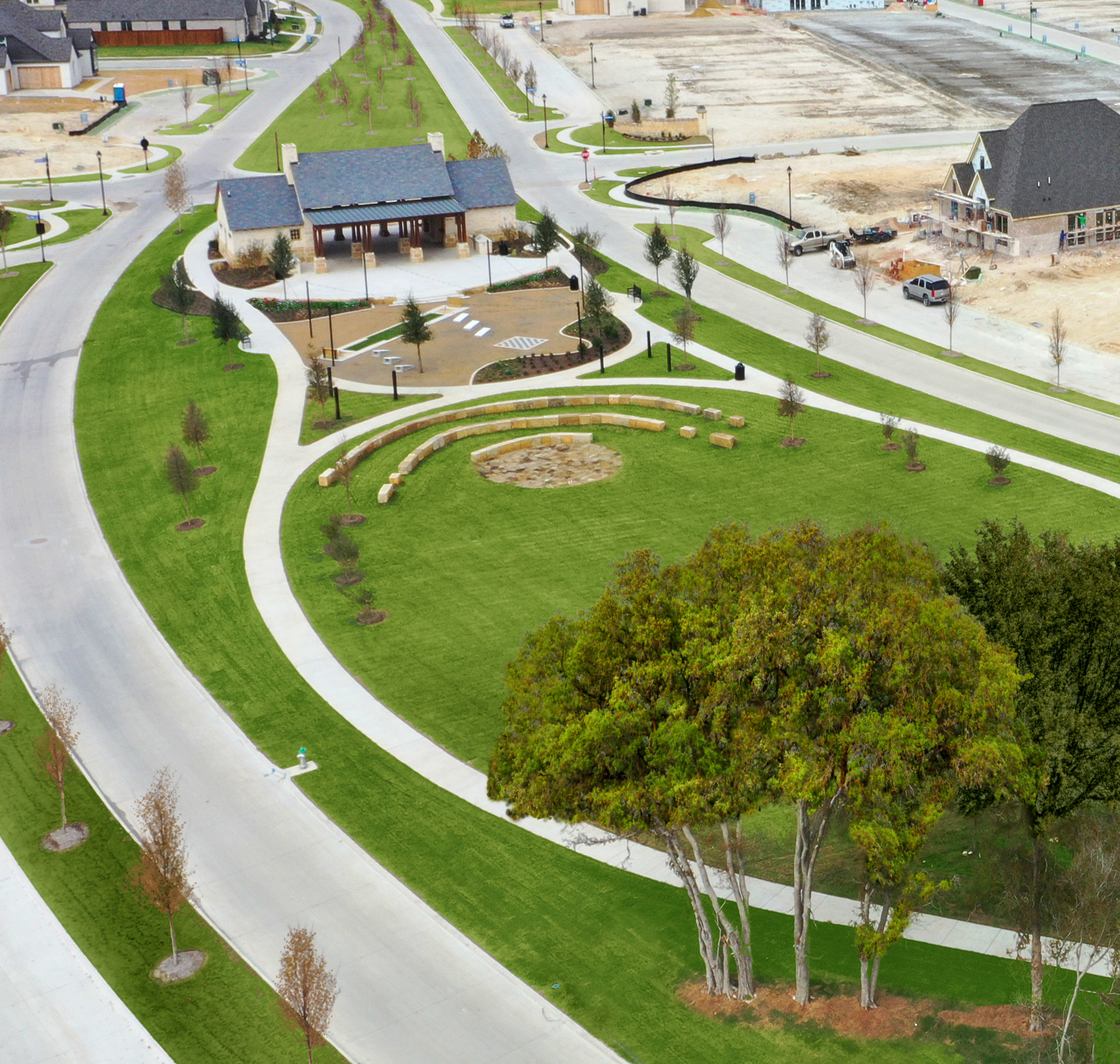 A well-designed residential community with neatly landscaped gardens, winding paths, and a mix of modern and traditional-style buildings in the background.