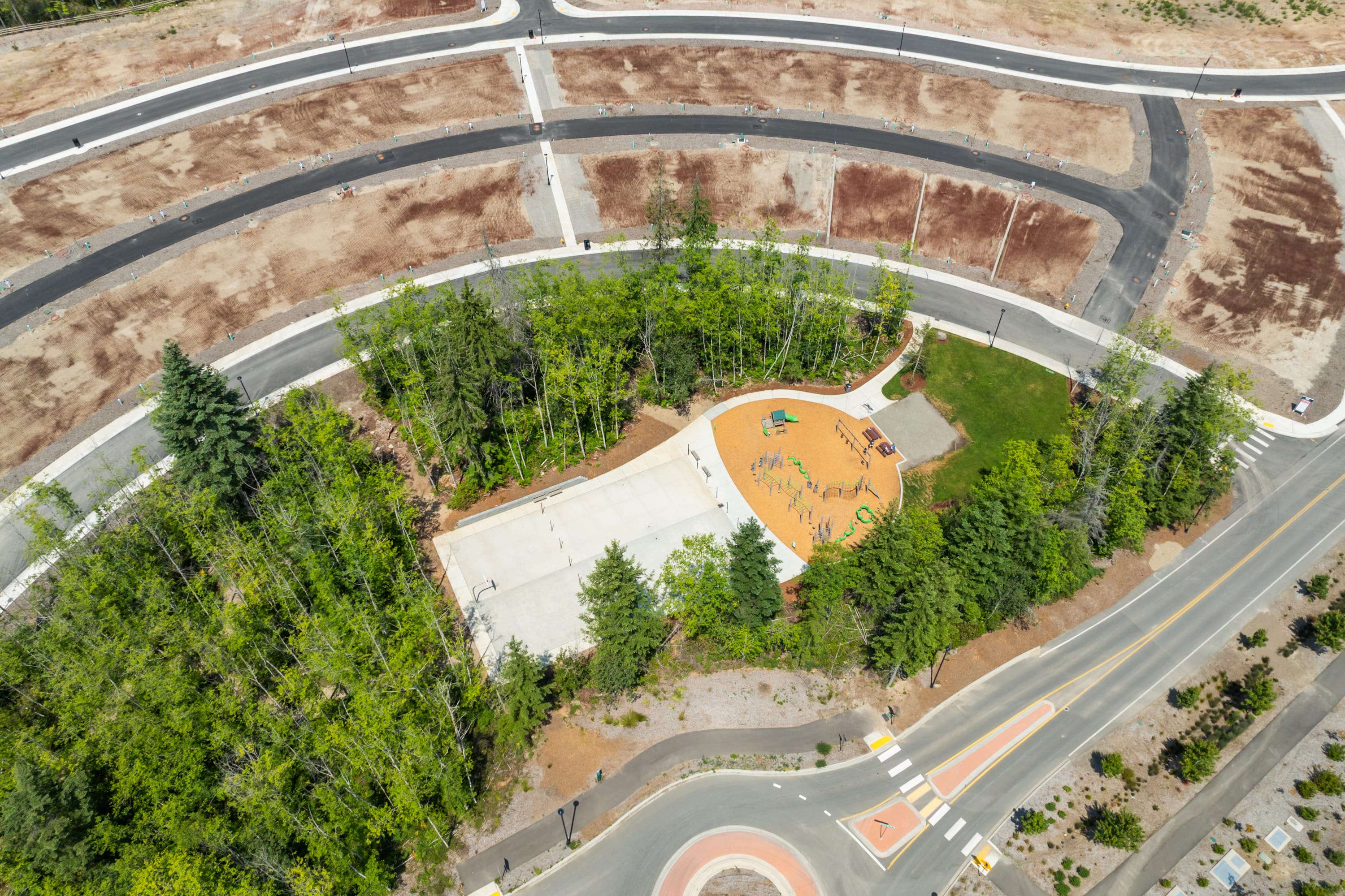 The image shows a bird's-eye view of a landscaped area with winding paths, green vegetation, and a central structure with a distinctive orange roof.