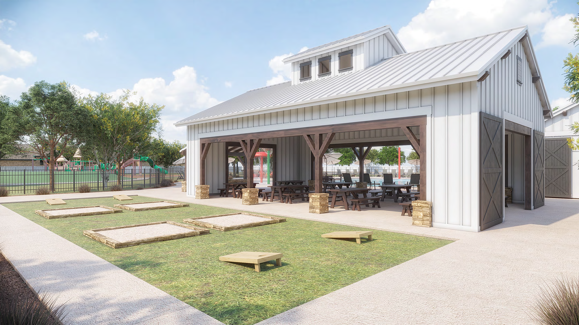 A modern, rustic-style building with a covered patio area surrounded by a grassy lawn and landscaping, providing an inviting outdoor dining or gathering space.