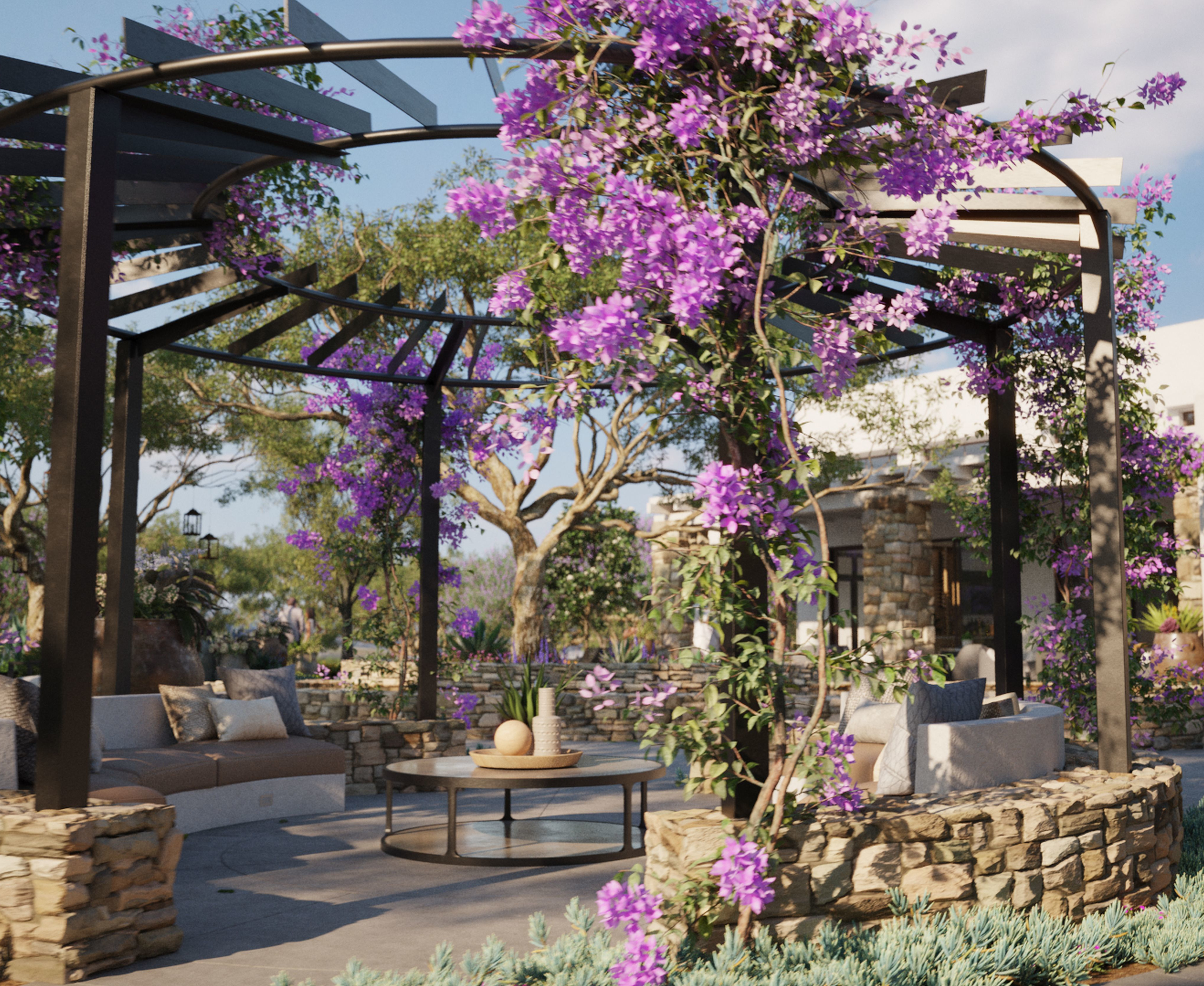 A lush, outdoor seating area with a pergola covered in vibrant purple flowers, surrounded by stone walls and greenery, creating a serene and inviting atmosphere.
