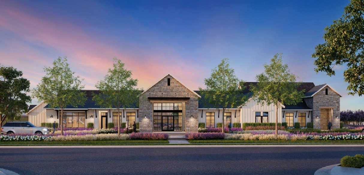 A charming stone and wood building with a triangular roof stands amidst a lush landscape of trees and flowering plants, set against a vibrant sky with a warm, colorful sunset.