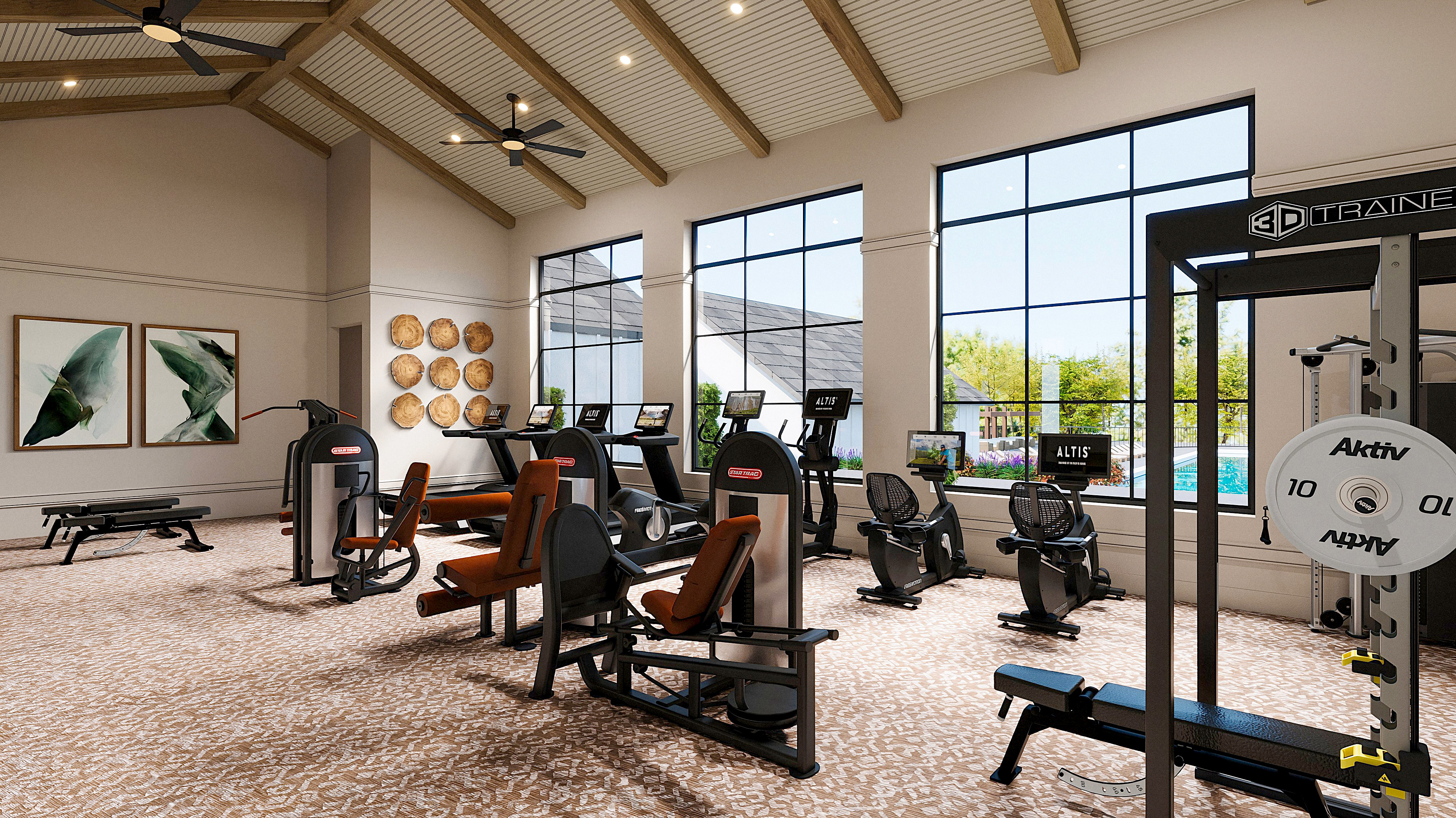 A spacious and well-equipped gym with various exercise equipment, high ceilings, and large windows providing natural light, set against a backdrop of artwork and decor.