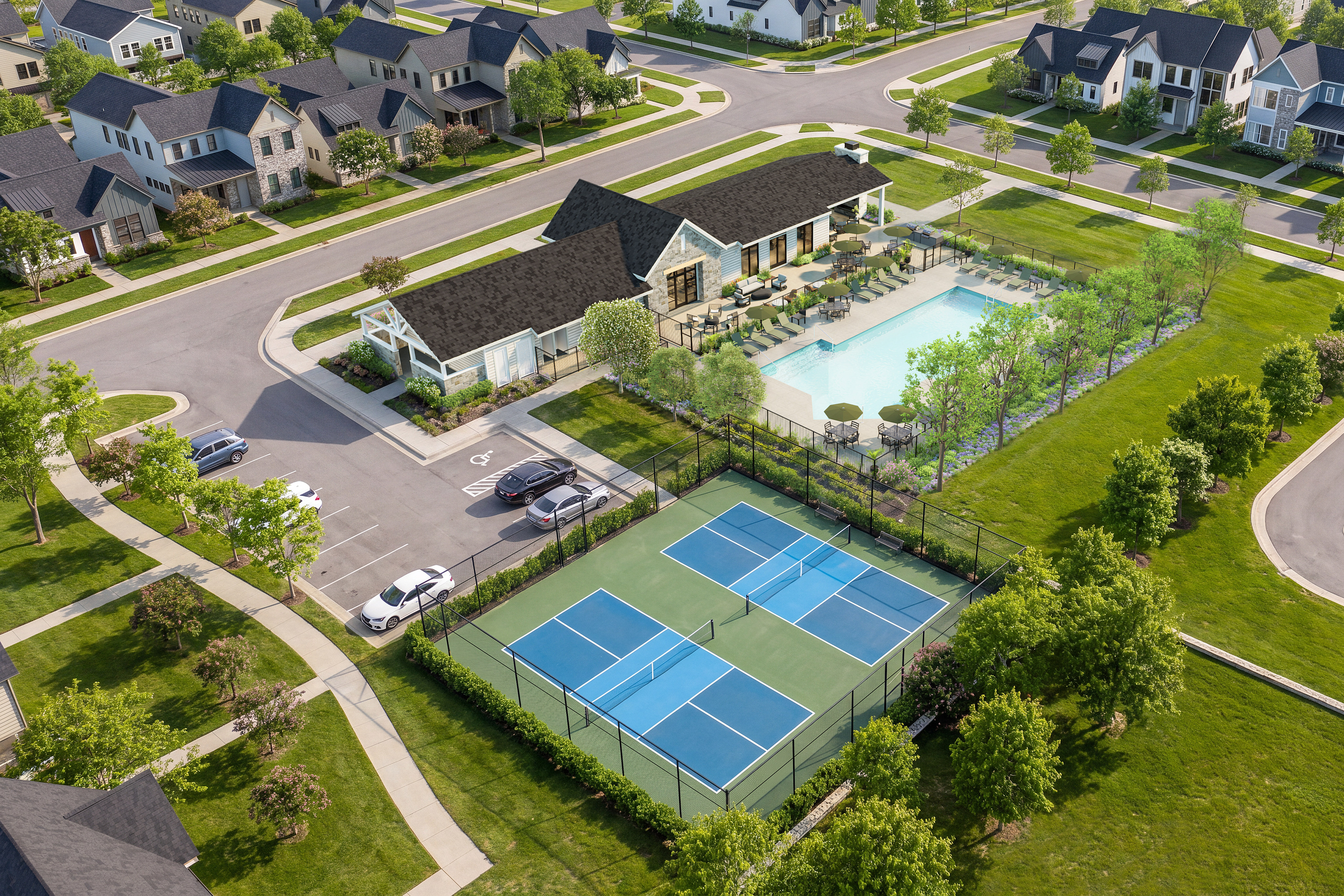 In the foreground, two pickleball courts are visible, while the background features a swimming pool and a cluster of houses.
