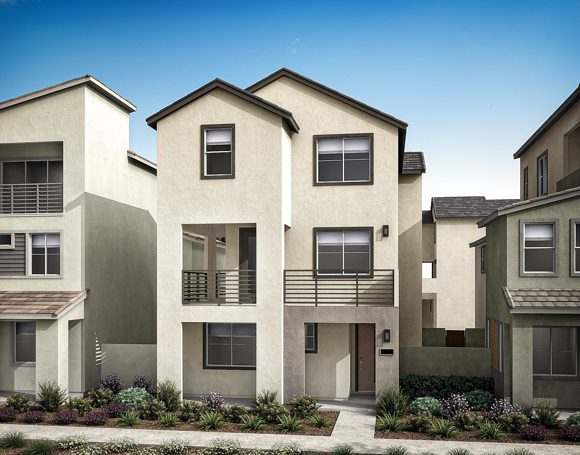 The image depicts a row of modern, multi-story residential buildings with stucco exteriors and slanted roofs, set against a clear blue sky in the background.