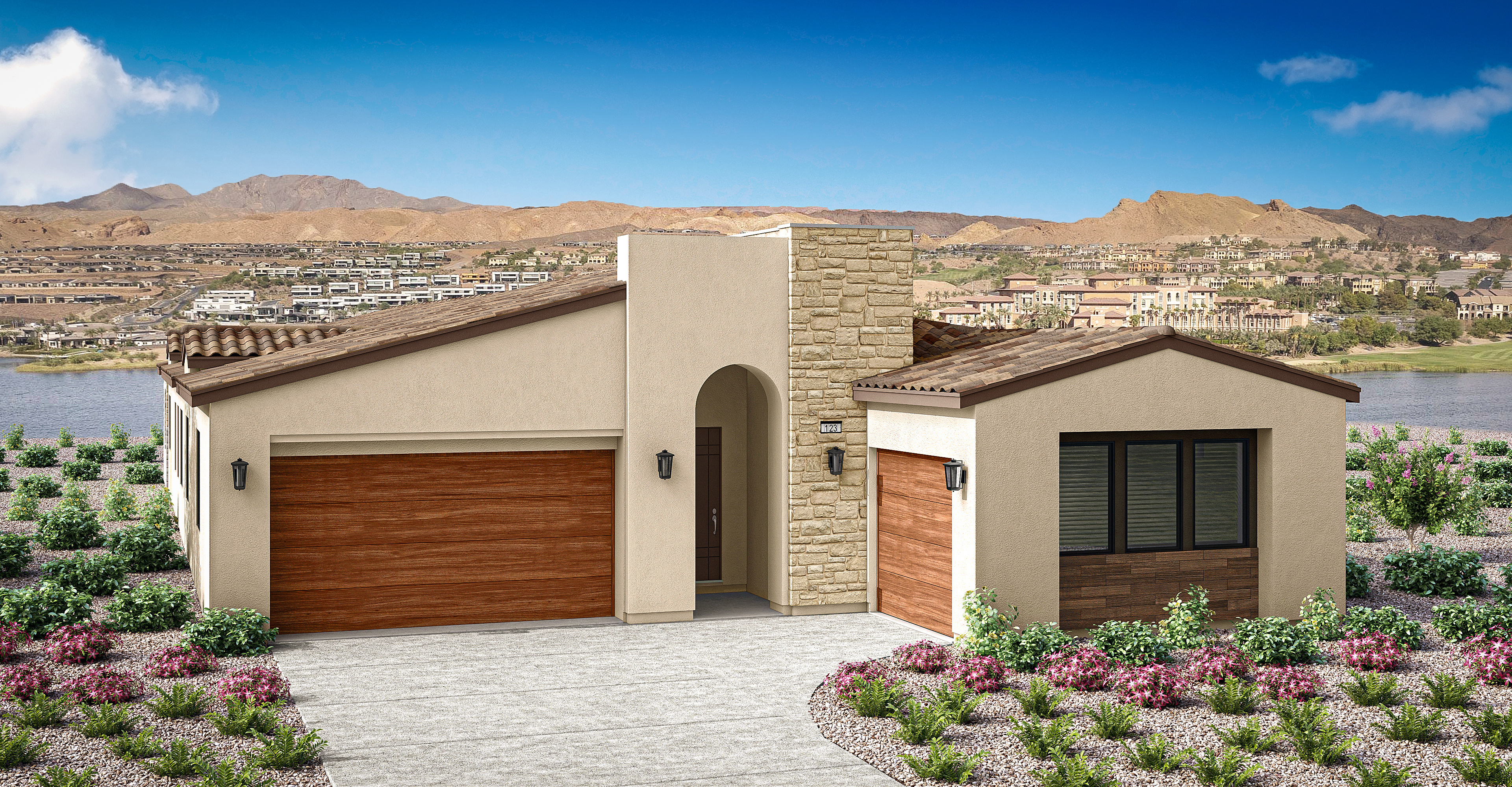 The image depicts a modern, two-story residential building with a wooden garage door and a small garden in the foreground. In the background, a mountainous landscape can be seen under a clear blue sky.
