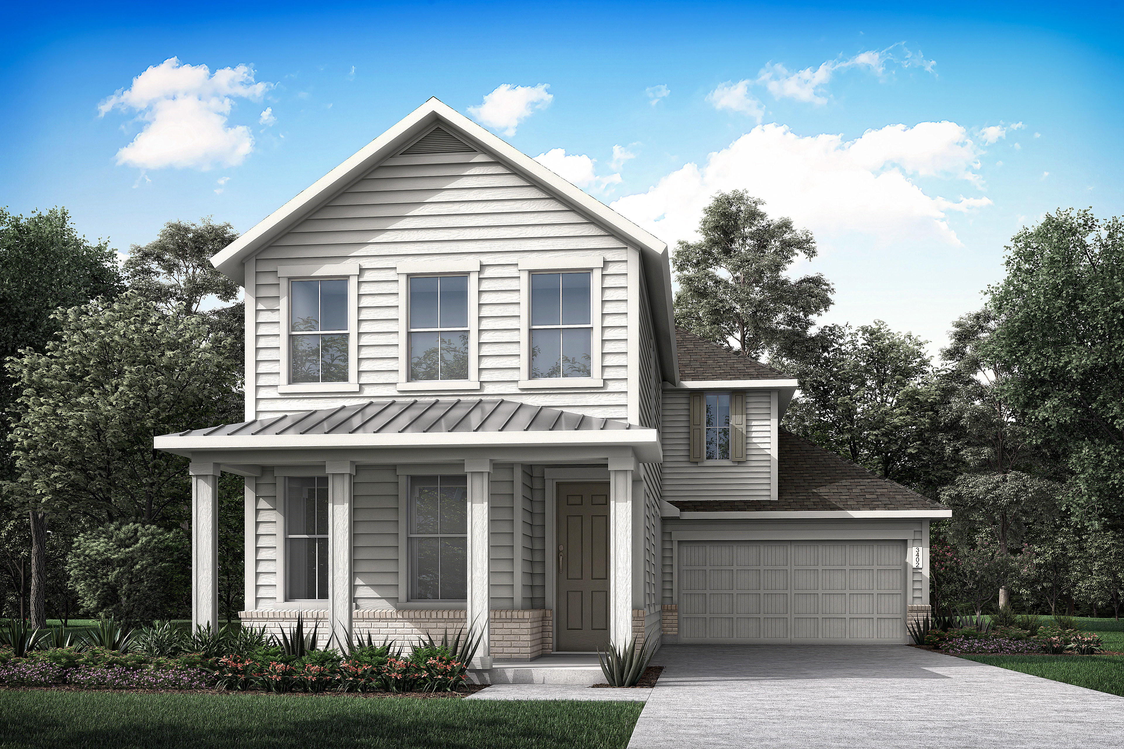 A two-story gray wooden house with a gabled roof stands in a lush, green landscape, surrounded by trees and a clear blue sky with fluffy white clouds.